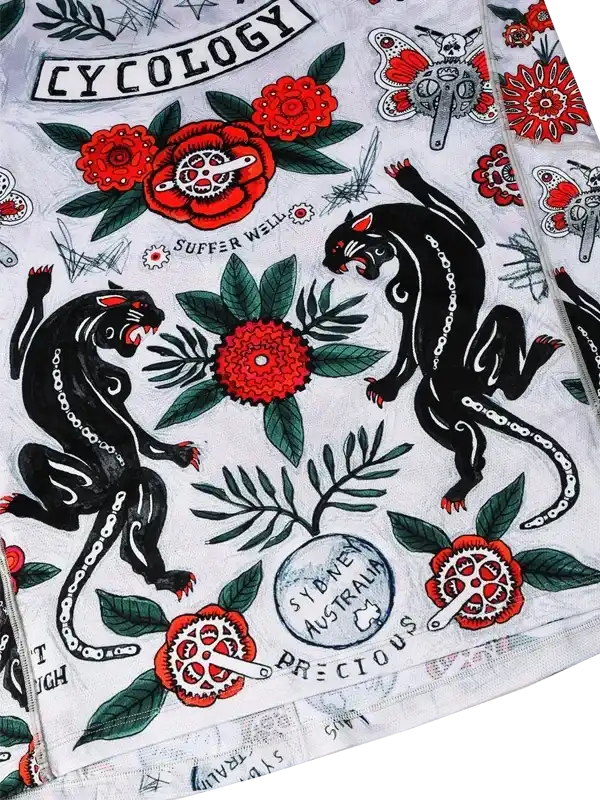 Cycling jersey with bold black panthers, red flowers, and bike gear designs on white fabric