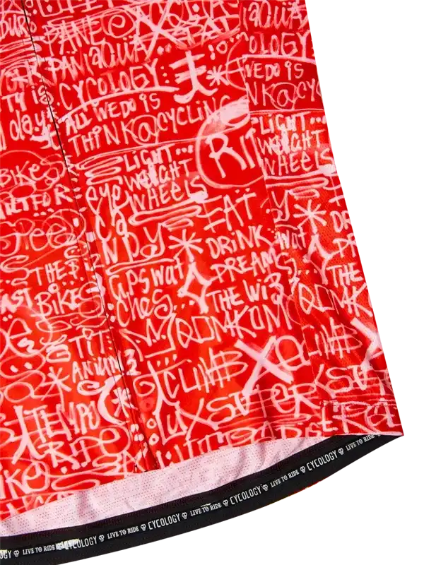Red cycling jersey with white graffiti-style text and 'Cycology' branding on hem