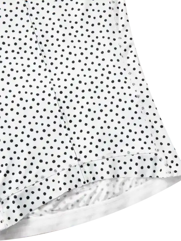 White cycling jersey with black polka dots, close-up of hem and stitching detail