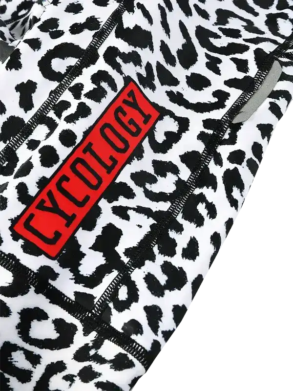 Cycology leopard print cycling shorts with red logo patch and black stitching detail