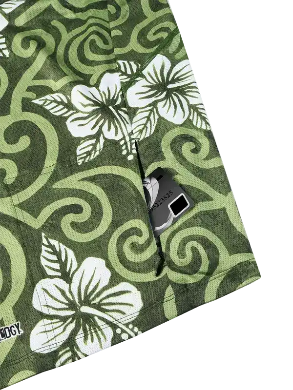Green cycling shorts with white hibiscus floral print and swirl pattern, featuring rear pocket with zipper