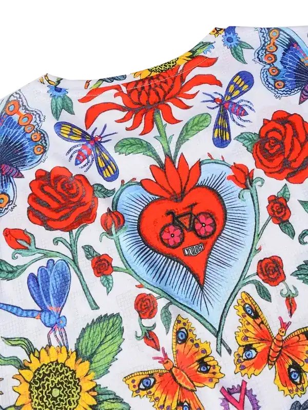 Vibrant floral and butterfly print cycling jersey with heart and bike motif, ideal for women's cycling apparel