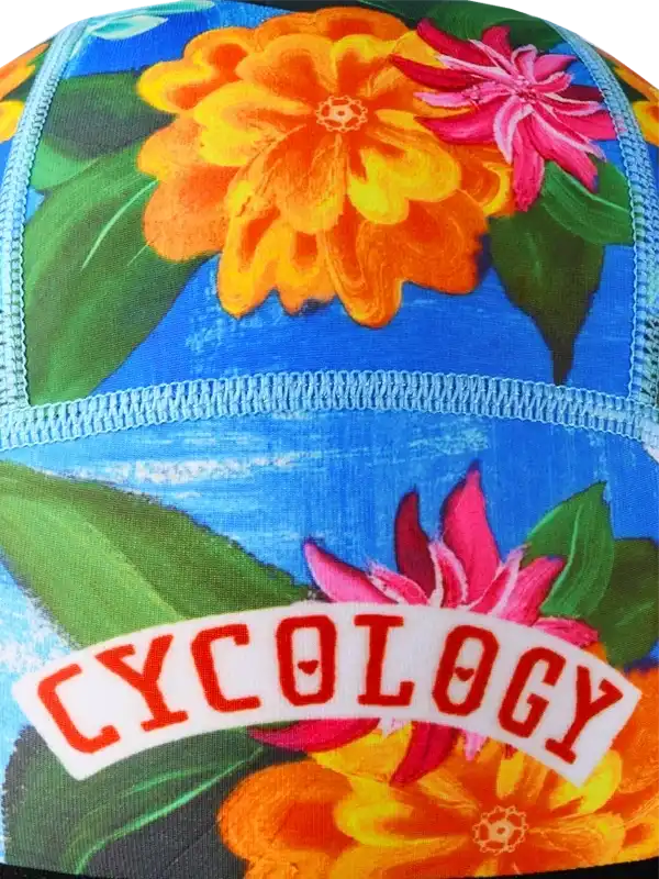 Cycology floral cycling cap with vibrant orange and pink flowers on blue background, ideal for bike rides.