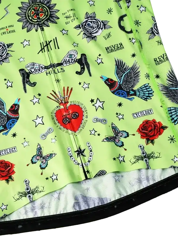 Vibrant green cycling jersey with tattoo-style graphics, roses, birds, and stars for men and women