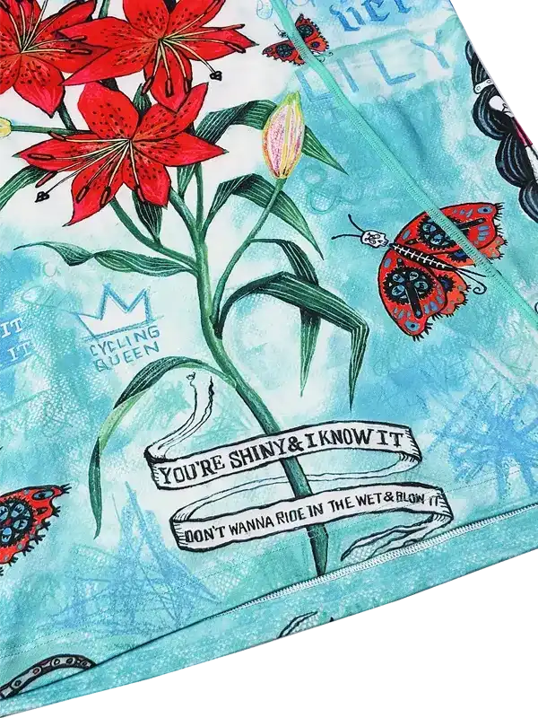 Cycling jersey with red lilies, butterflies, and 'Cycling Queen' text on teal background