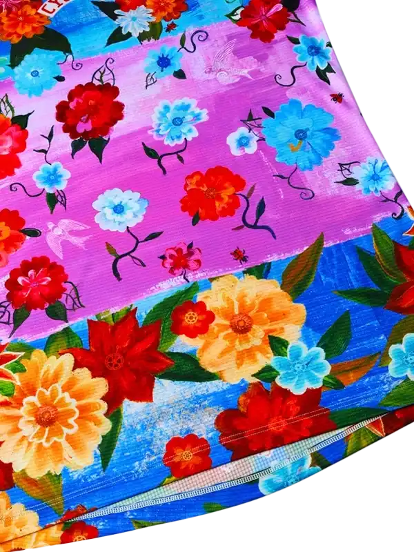 Vibrant floral cycling jersey with red, blue, and yellow flowers on purple and blue background
