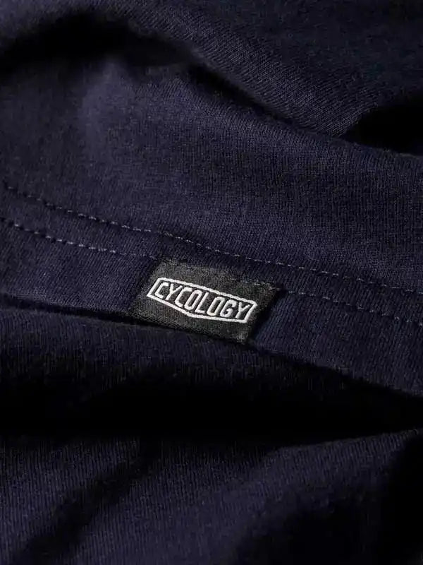 Cycology brand tag on dark navy cycling apparel, showcasing premium fabric detail