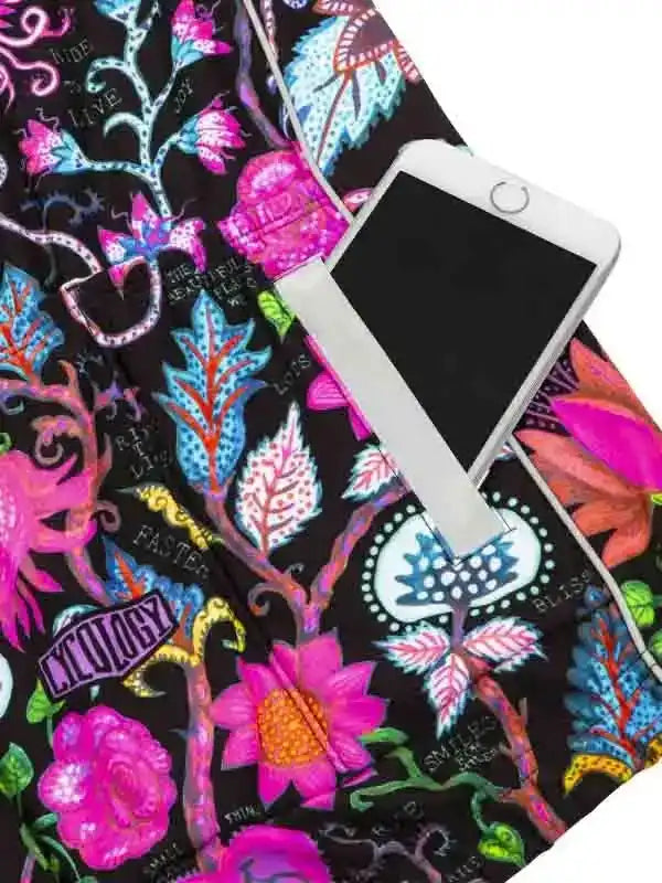 Vibrant floral cycling shorts with phone pocket, featuring bold pink, blue, and black patterns for women's bike wear.