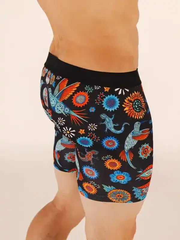 Men's cycling shorts with vibrant hummingbird and floral print on black fabric