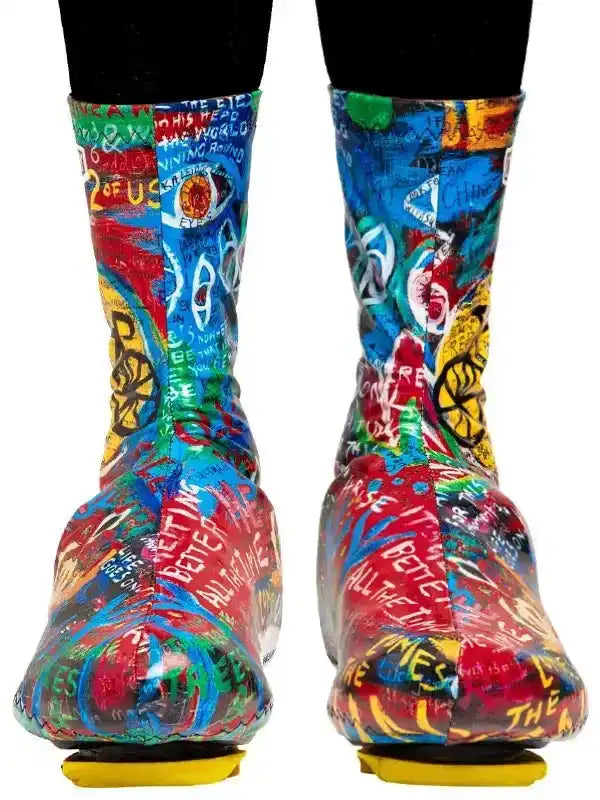 Colorful graffiti-style cycling shoe covers with bold text and vibrant patterns for road bike riders