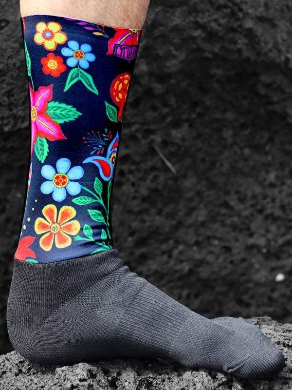 Colorful floral cycling socks with vibrant flowers on dark background, perfect for bike rides