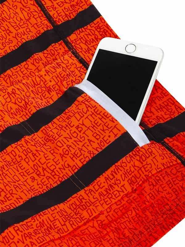 Orange cycling shorts with black stripes and motivational text, featuring a phone pocket for on-the-go rides.