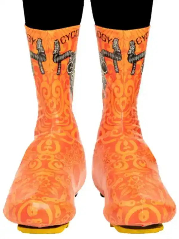 Orange cycling shoe covers with bike graphic and swirl pattern for men and women