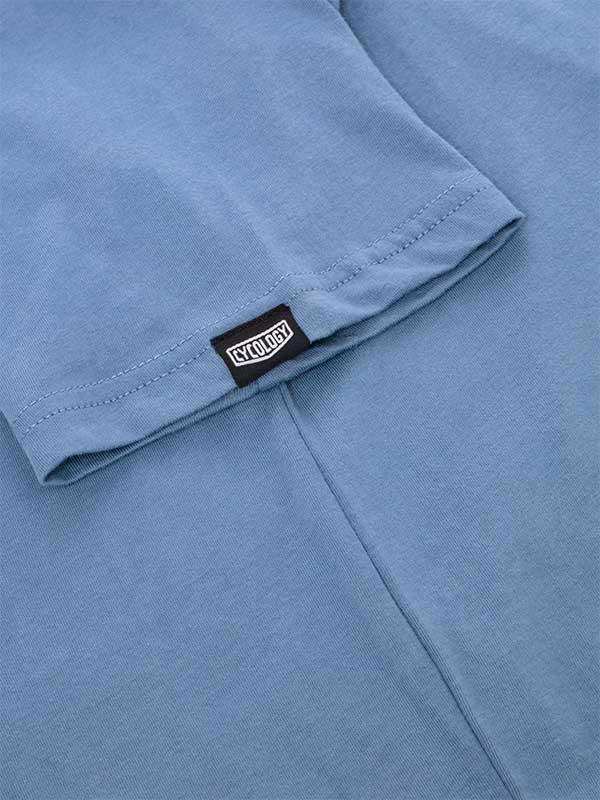 Light blue cycling jersey sleeve with Cycology brand tag, high-quality fabric detail
