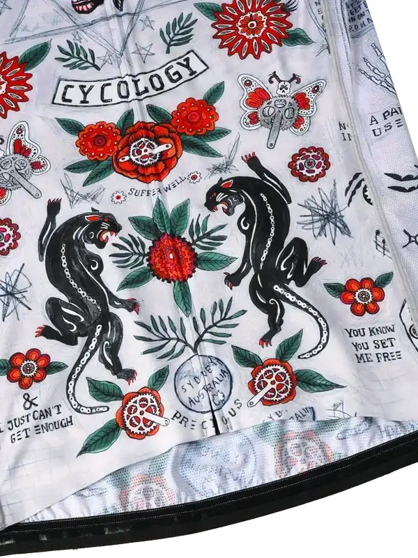 Cycology cycling jersey with bold tattoo-style panther, floral, and gear designs on white fabric