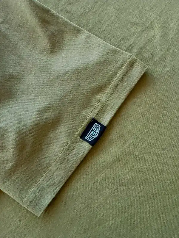 Olive green cycling jersey sleeve with branded tag, high-quality fabric detail