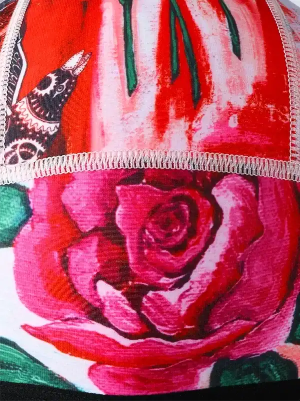 Vibrant red rose and bird print on cycling jersey fabric with detailed stitching