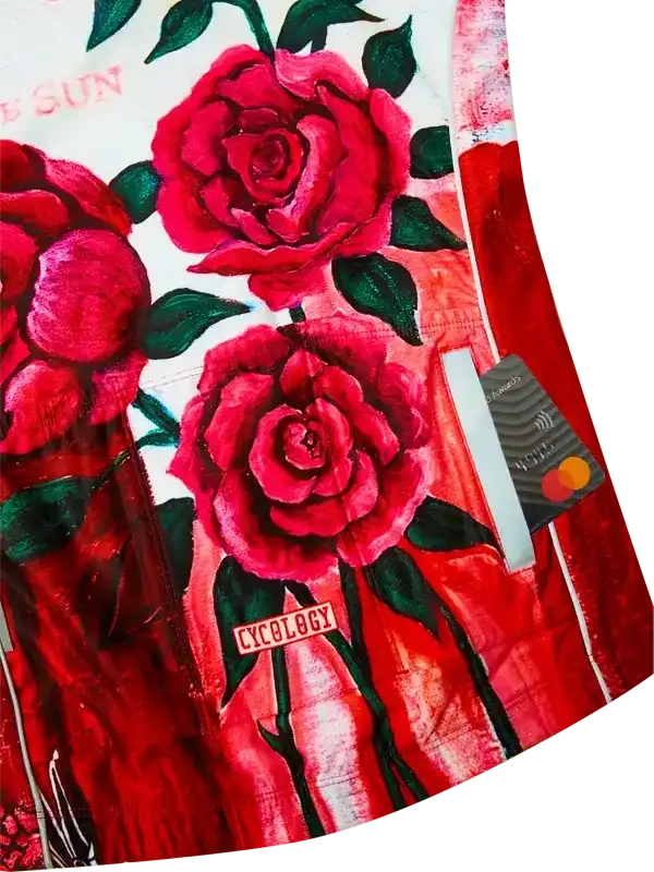 Vibrant red rose print cycling jersey with green leaves and 'Cycology' tag, stylish women's bike wear