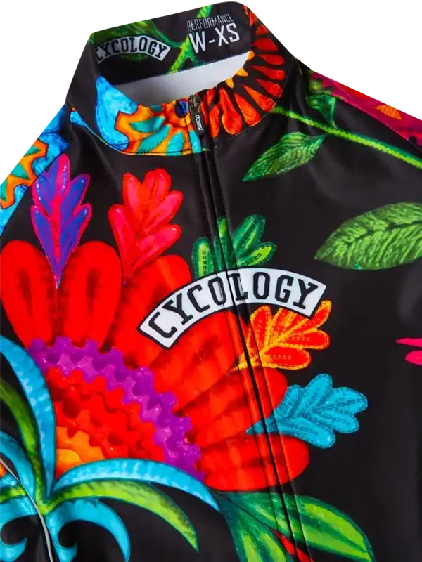 Vibrant floral cycling jersey with bold colors and Cycology logo, designed for performance and style.