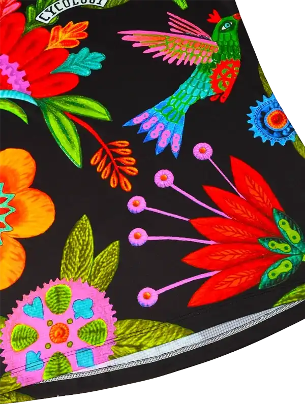 Vibrant floral and hummingbird print cycling shorts with bold colors on black fabric