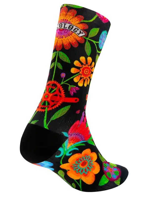 Colorful floral cycling socks with gear design, vibrant flowers on black background for bike rides