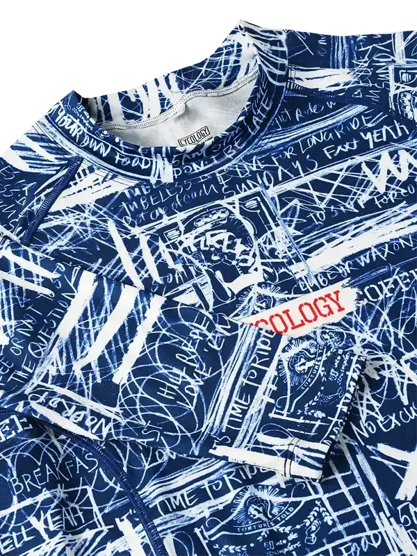 Blue cycling jersey with white graffiti-style graphics and 'OLOGY' text, featuring bold cycling-themed designs.