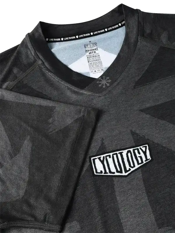 Cycology men's cycling jersey with geometric camo print, performance fabric, and branded chest patch