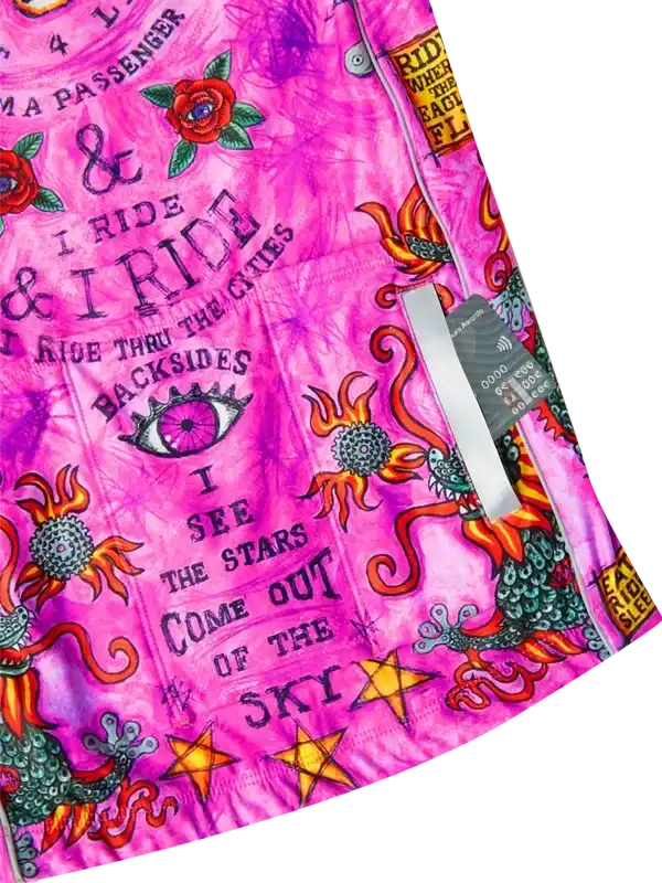 Vibrant pink cycling jersey with bold graphics, roses, stars, and 'I ride' text for men's and women's bike wear.
