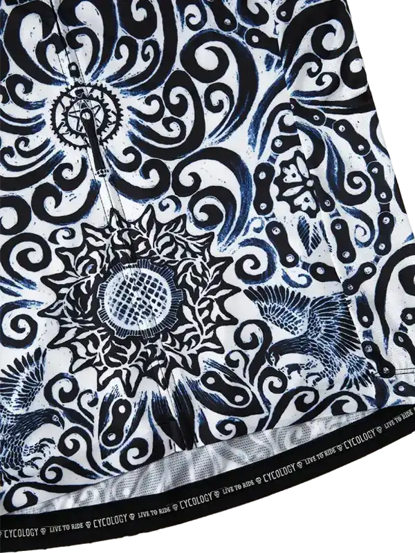 Black and white cycling jersey with intricate swirls, sunburst, and bird designs, featuring 'Live to Ride' hem text.