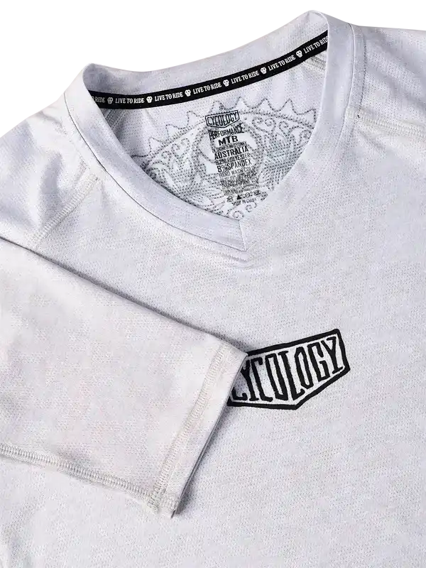 White cycling jersey with 'Cycology' logo and 'Live to Ride' neck tape, performance MTB design