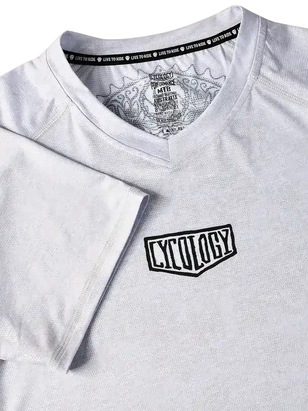 White men's cycling jersey with 'CYCOLOGY' chest logo and 'LIVE TO RIDE' neck tape, breathable fabric