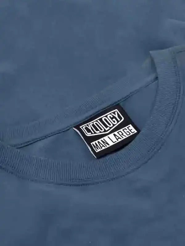 Cycology men's large size tag on blue cycling apparel, high-quality fabric detail