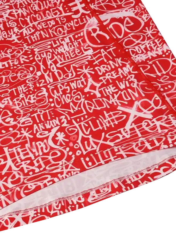 Red cycling jersey with white graffiti-style text, featuring words like 'RIDE' and 'CLIMB' for men's and women's bike wear.