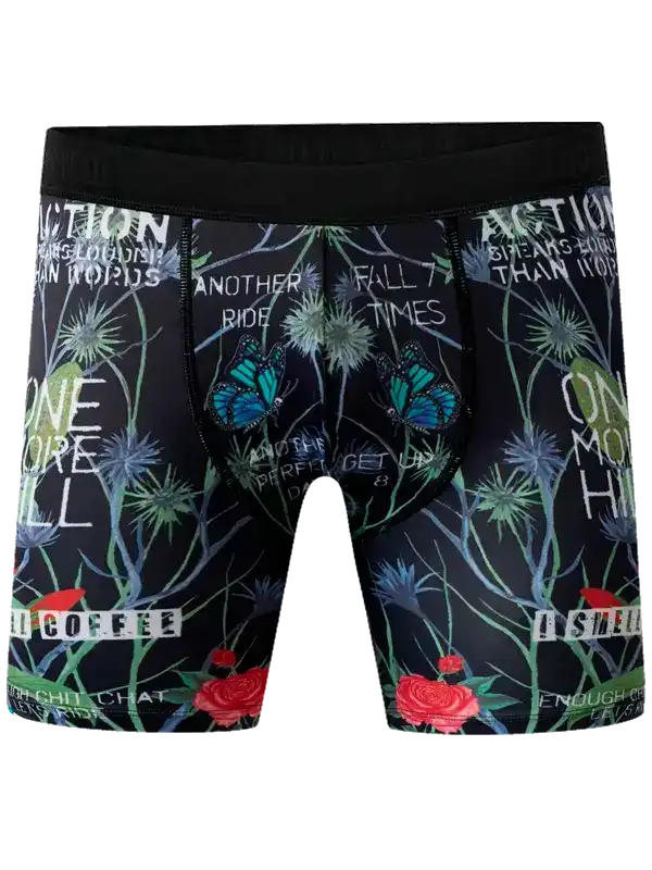 Men's cycling shorts with butterfly, floral, and motivational text print on black fabric