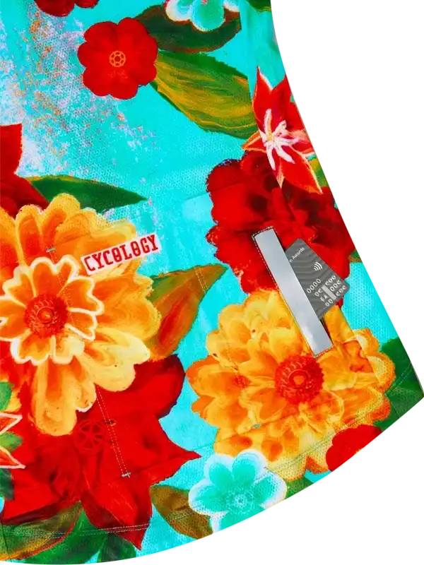 Vibrant floral cycling jersey with bold red, orange, and teal flowers on breathable fabric for women's bike rides