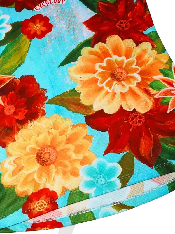 Vibrant floral cycling jersey with bold red, orange, and blue flowers on turquoise background, featuring breathable fabric and stylish design.