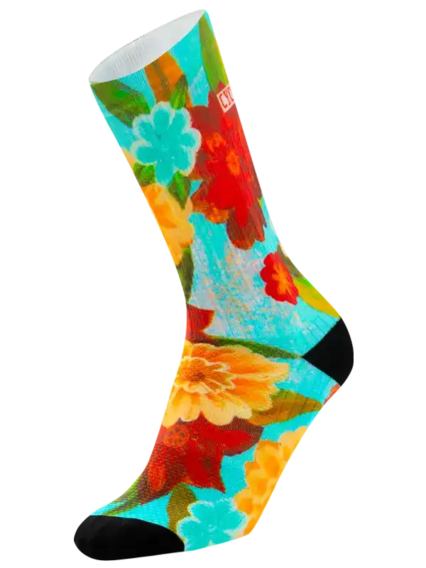 Colorful floral cycling socks with vibrant red, orange, and teal blooms on turquoise background