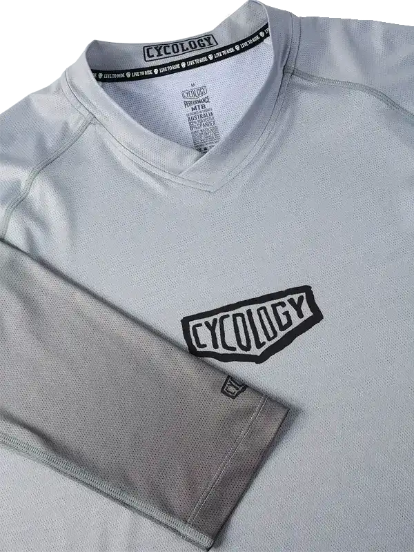 Cycology men's cycling jersey in light gray with bold black logo, breathable mesh fabric, V-neck design