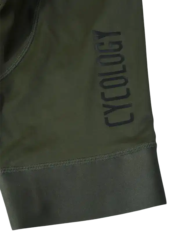 Olive green cycling shorts with 'CYCOLOGY' logo, high-quality fabric, designed for men and women