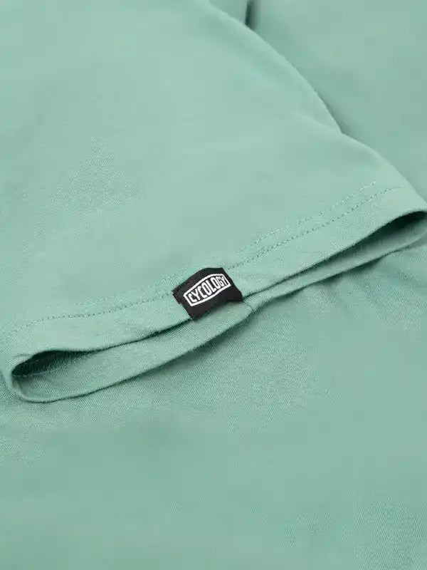 Mint green cycling jersey with CYCOLOGY tag, high-quality fabric detail for men's and women's bike wear