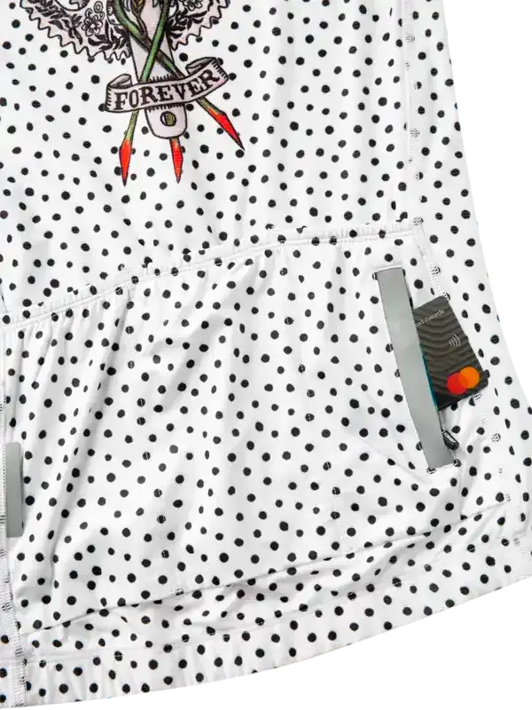 White cycling jersey with black polka dots and floral 'Forever' design, featuring rear pockets.