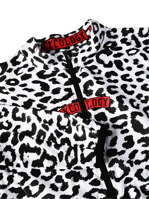 Cycling jersey with bold black and white leopard print, red 'CYCOLOGY' logo on collar and chest, zipper front.