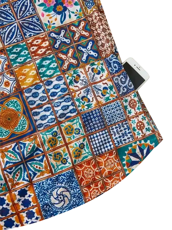 Colorful tile-patterned cycling jersey with phone pocket, featuring vibrant geometric and floral designs.