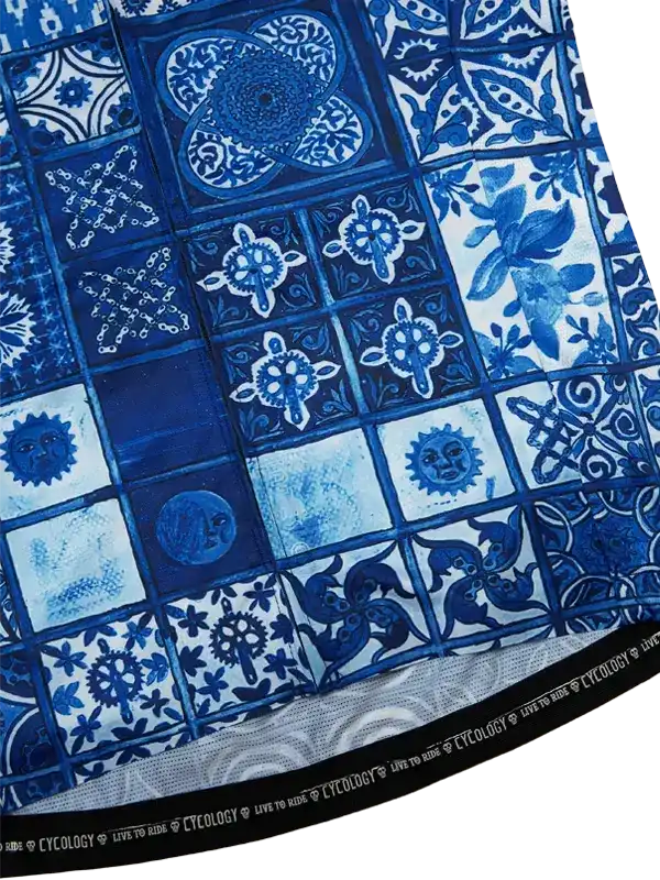 Blue and white patterned cycling jersey with intricate tile designs and gear motifs