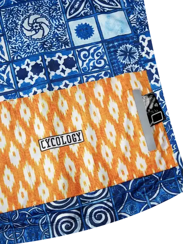 Cycology cycling jersey with blue tile and orange ikat pattern, featuring brand label and tech pocket