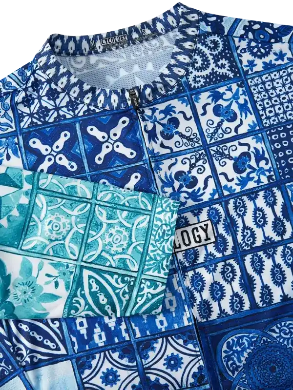 Blue and teal patterned cycling jersey with unique tile designs and zipper detail