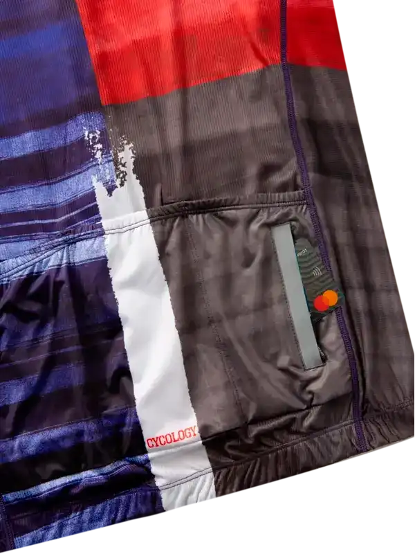 Cycology cycling jersey with bold red, blue, and gray panels, rear pocket, and reflective details for visibility
