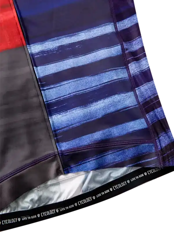 Blue and black striped cycling shorts with reflective details and brand waistband