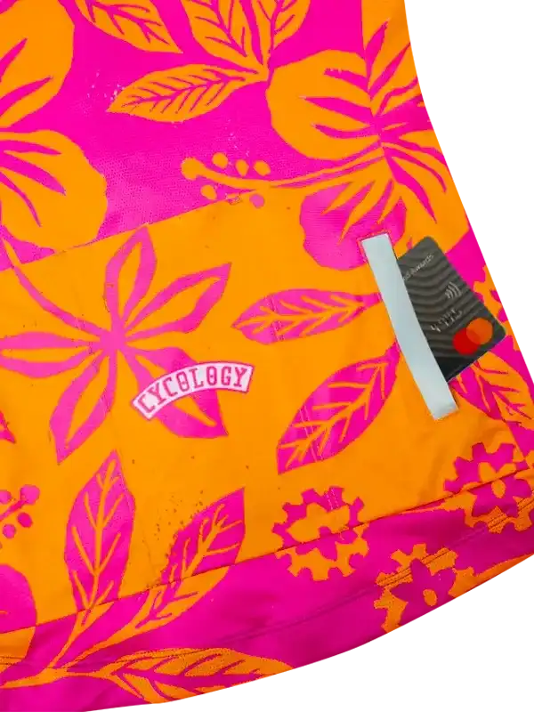 Vibrant pink and orange floral cycling jersey with rear pocket and reflective strip