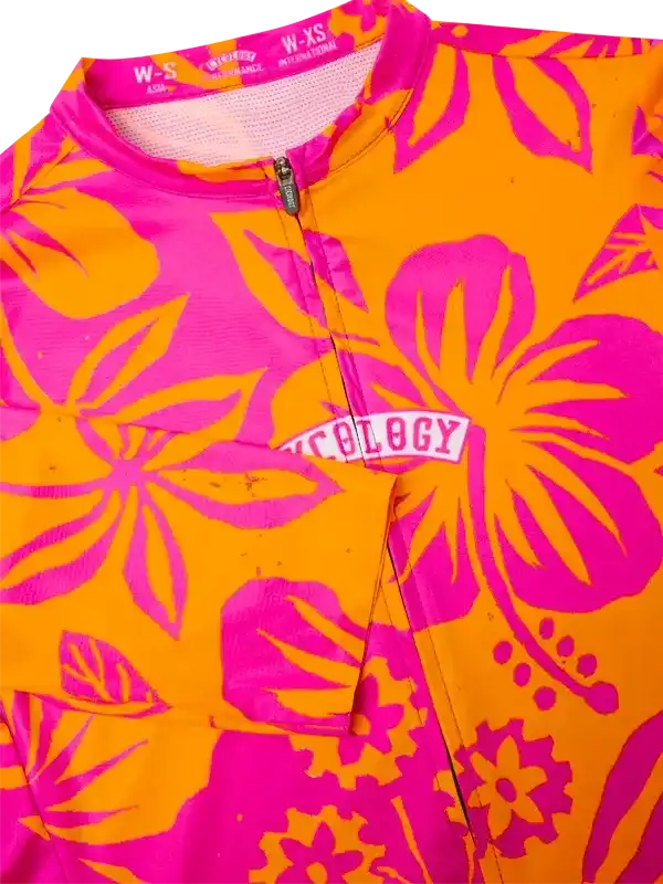 Vibrant pink and orange floral cycling jersey with full zip and 'Cycology' logo, designed for performance and style.